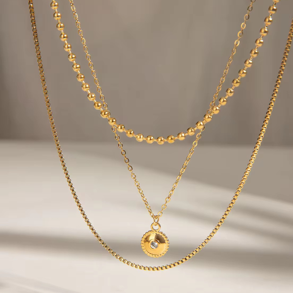 Inaya modern festive 18kt gold plated round charm & ball chain tripple layered necklace, star
