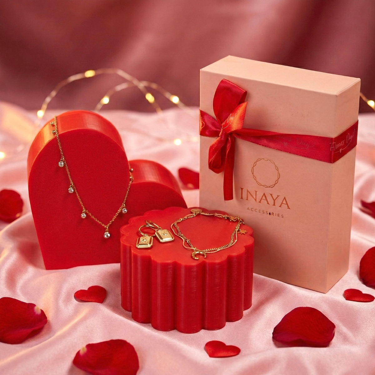 Jewelry set with a 'inaya' box on a red and pink fabric background